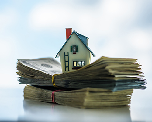 Small house on top of cash